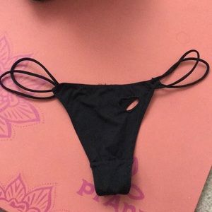 Black thong with heart cutout